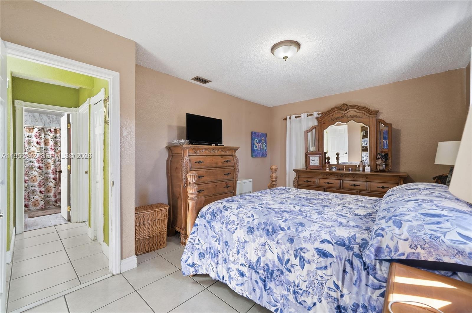4791 West 3rd Avenue Hialeah, FL 33012 - Photo 9 of 30 a bedroom with a bed and a flat screen tv