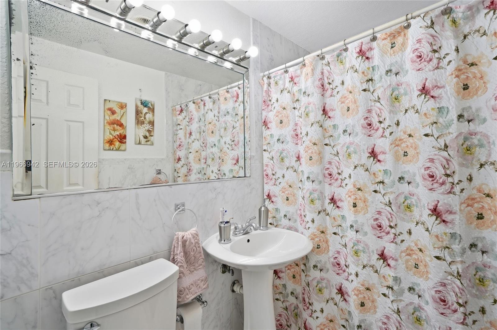 4791 West 3rd Avenue Hialeah, FL 33012 - Photo 10 of 30 a bathroom with a sink and mirror with toilet