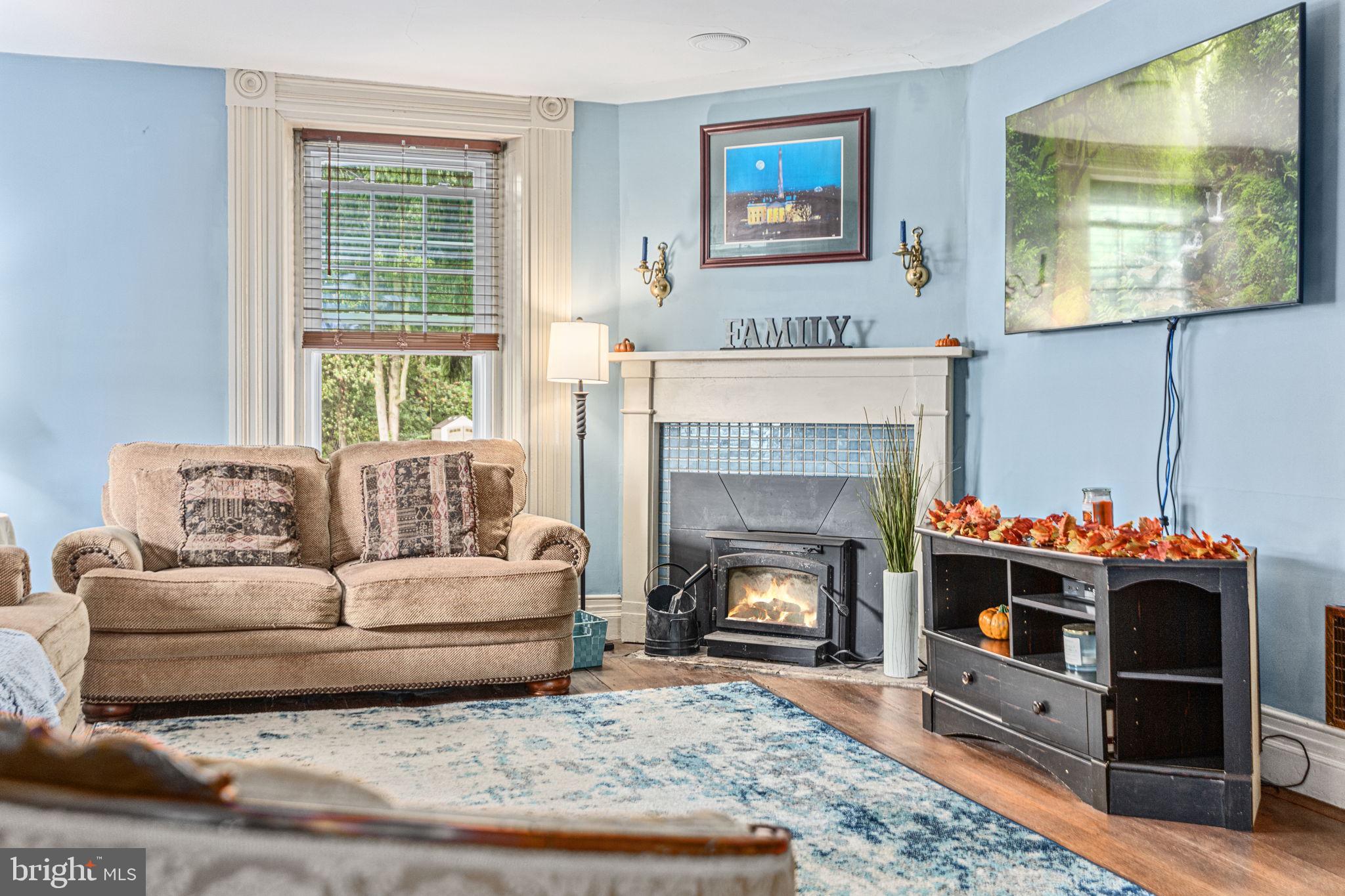 4701 Edges Mill Road Downingtown, PA 19335 - Photo 25 of 56 a living room with furniture and a fireplace