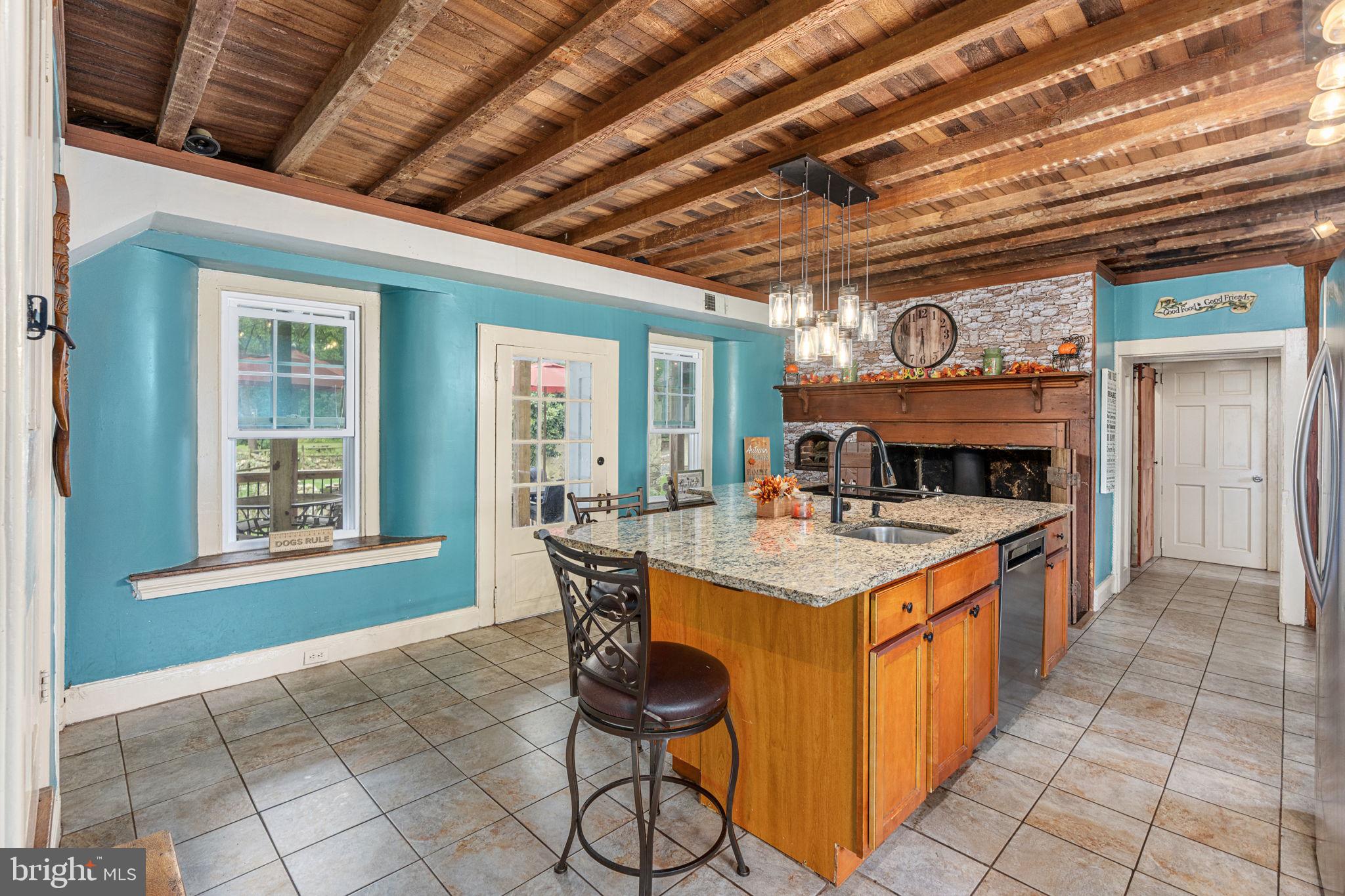 4701 Edges Mill Road Downingtown, PA 19335 - Photo 7 of 56 a open kitchen with stainless steel appliances granite countertop a stove a sink dishwasher and cabinets with wooden floor