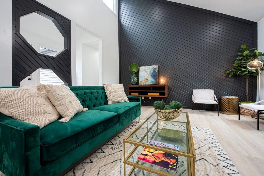 a living room with furniture and a potted plant