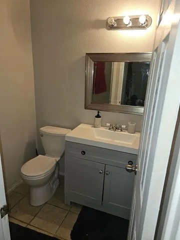 a bathroom with a sink toilet and mirror