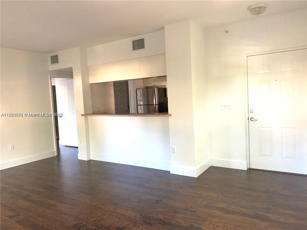 6776 West Sample Road, Unit 6776 Coral Springs, FL 33067 - Photo 11 of 20 a view of a refrigerator in an empty room