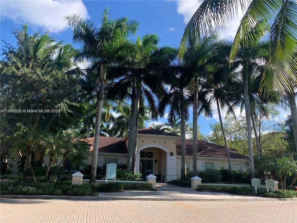 6776 West Sample Road, Unit 6776 Coral Springs, FL 33067 - Photo 15 of 20 front view of a house with a palm tree