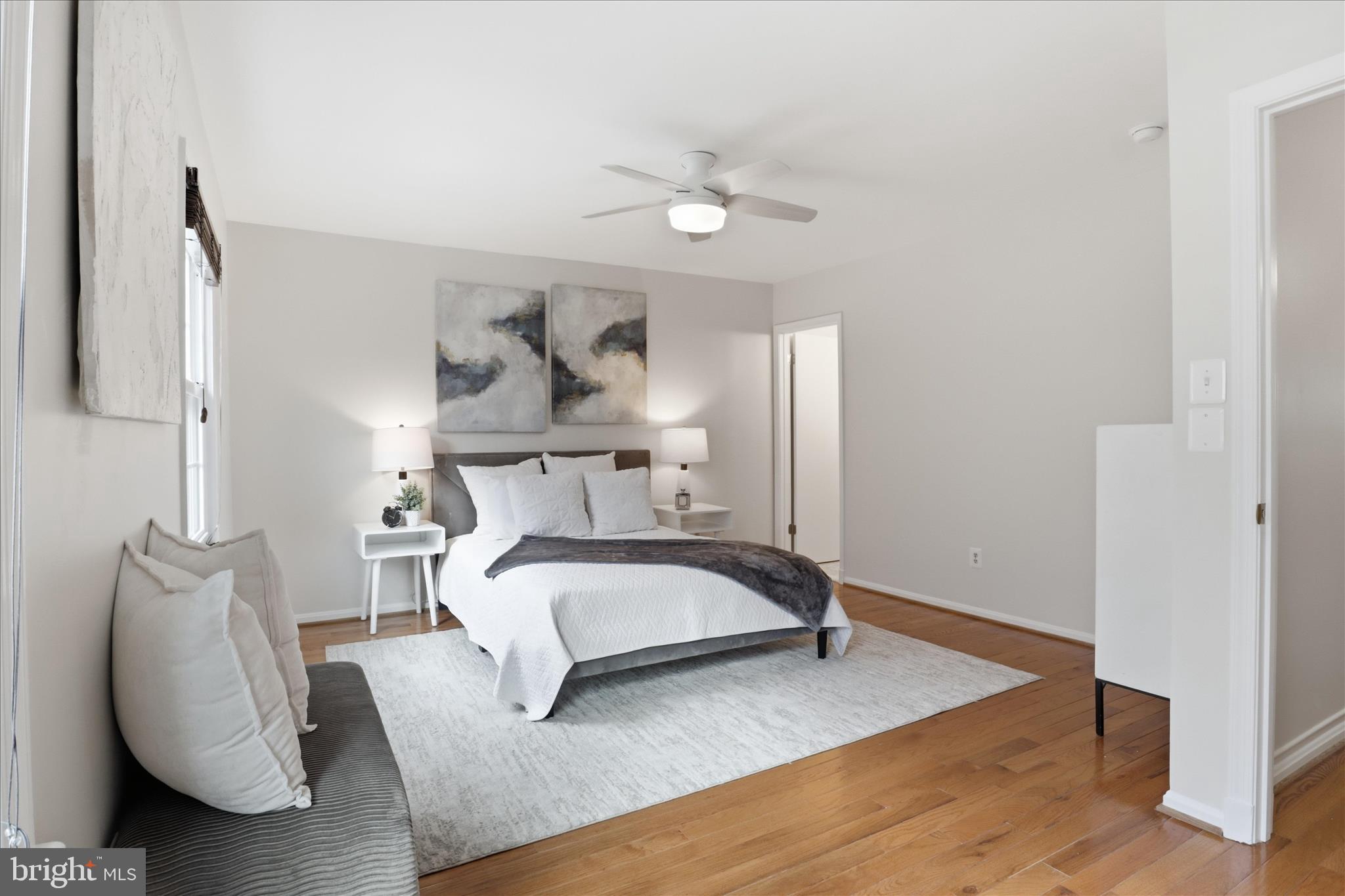 4851 Sangamore Road, Unit 25 Bethesda, MD 20816 - Photo 18 of 41 a bedroom with a bed and a chandelier