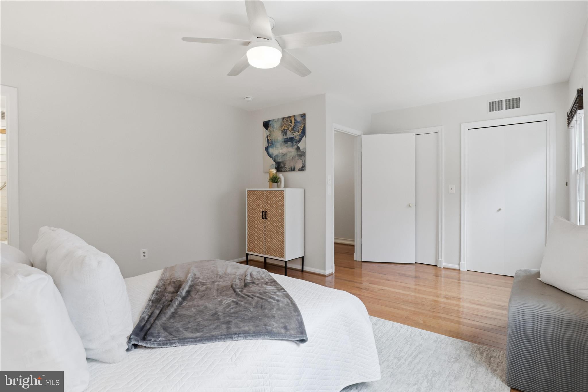 4851 Sangamore Road, Unit 25 Bethesda, MD 20816 - Photo 20 of 41 a bedroom with a bed and a chandelier