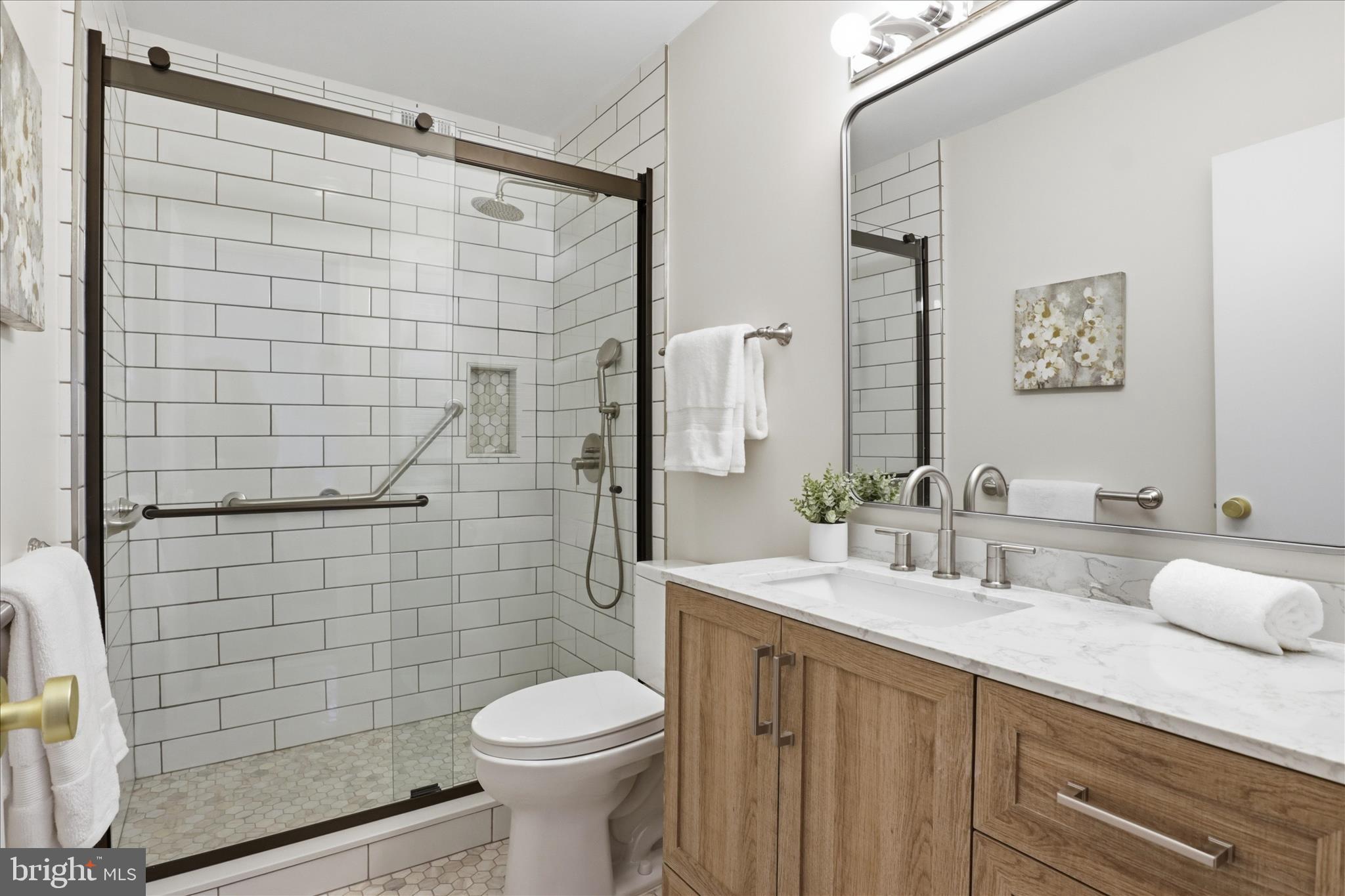 4851 Sangamore Road, Unit 25 Bethesda, MD 20816 - Photo 21 of 41 a bathroom with a sink a toilet and shower