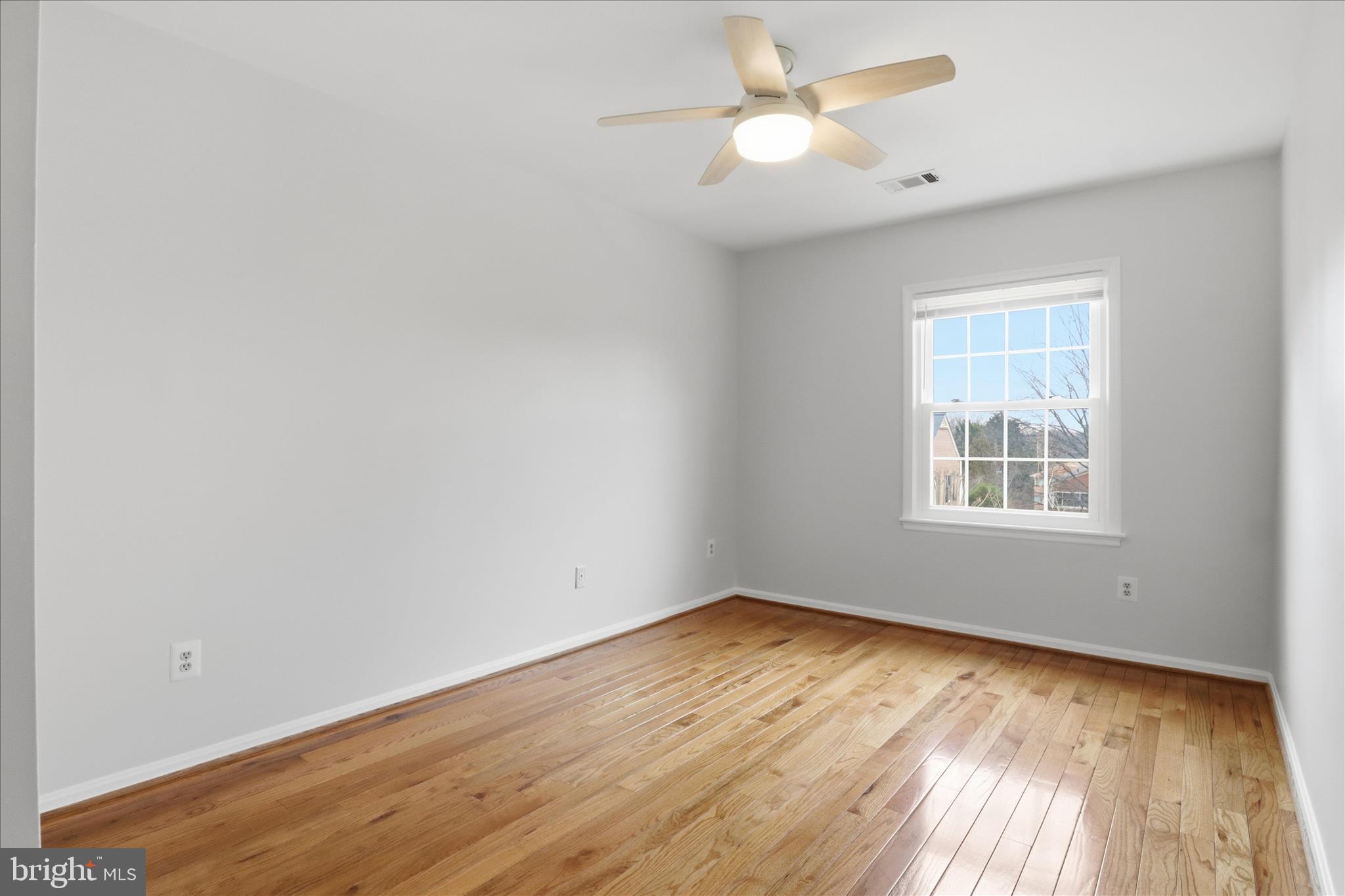 4851 Sangamore Road, Unit 25 Bethesda, MD 20816 - Photo 24 of 41 wooden floor in an empty room with a window