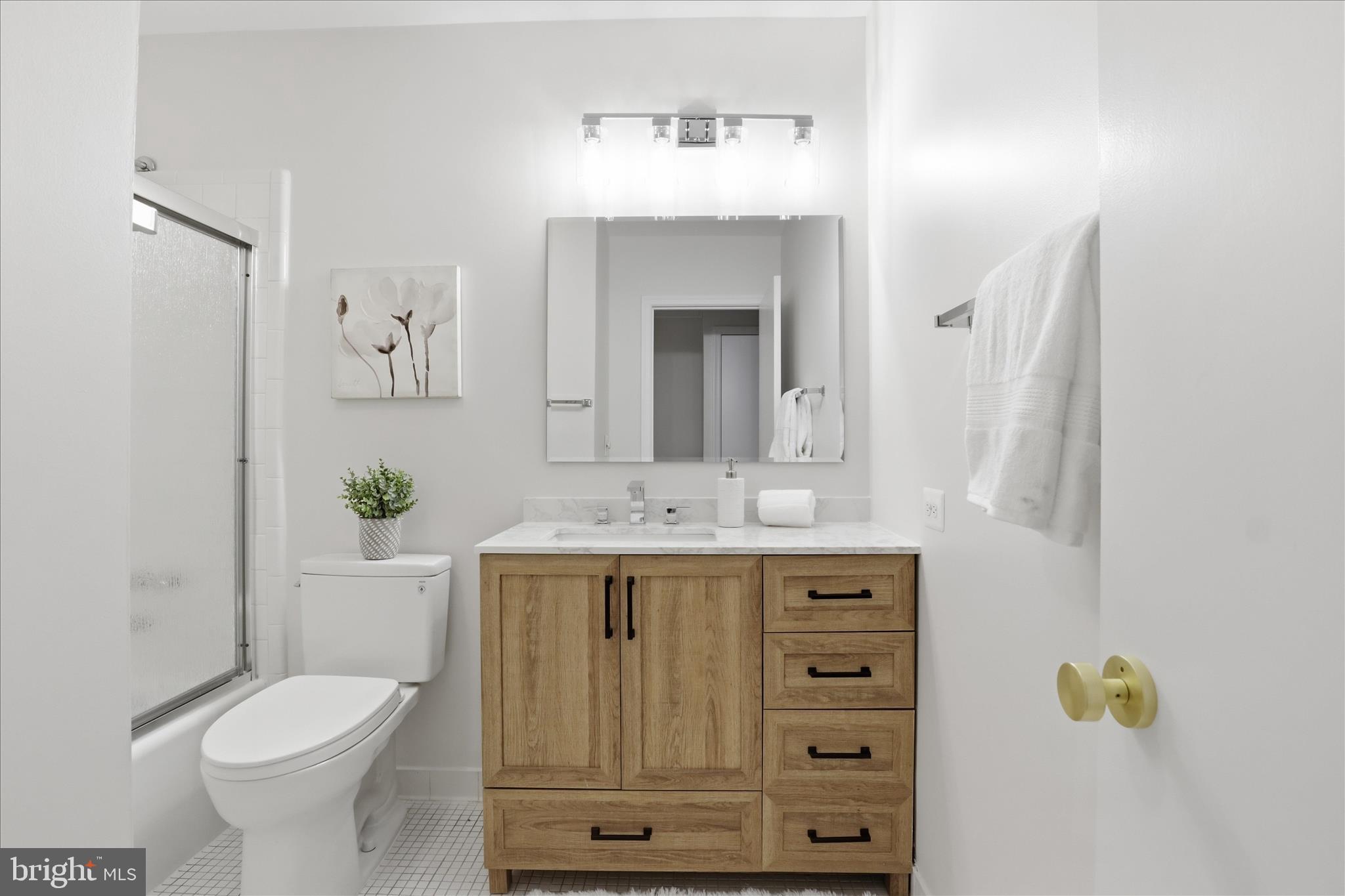 4851 Sangamore Road, Unit 25 Bethesda, MD 20816 - Photo 25 of 41 a bathroom with a sink toilet and shower