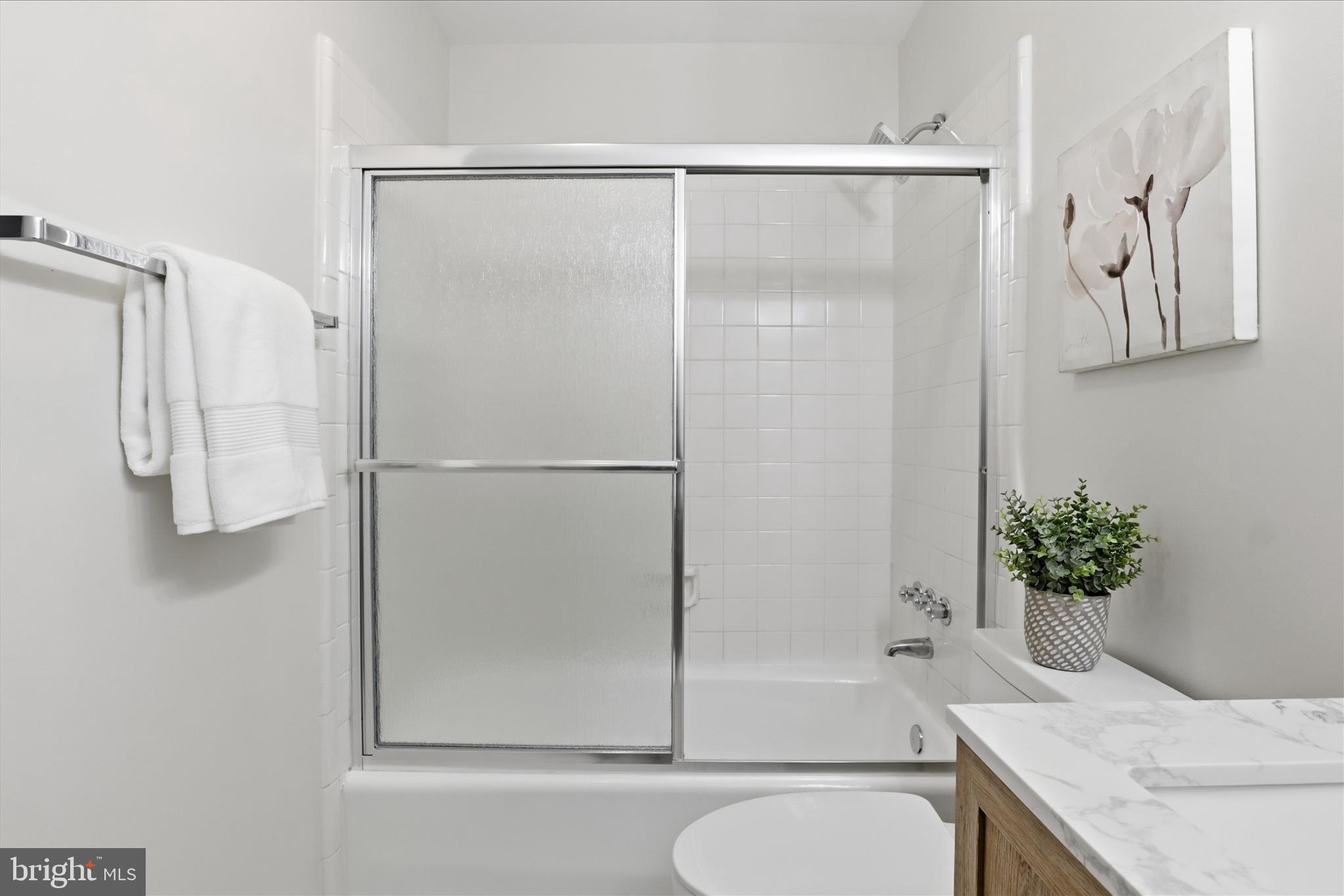 4851 Sangamore Road, Unit 25 Bethesda, MD 20816 - Photo 26 of 41 a bathroom with a granite countertop bathtub shower and sink