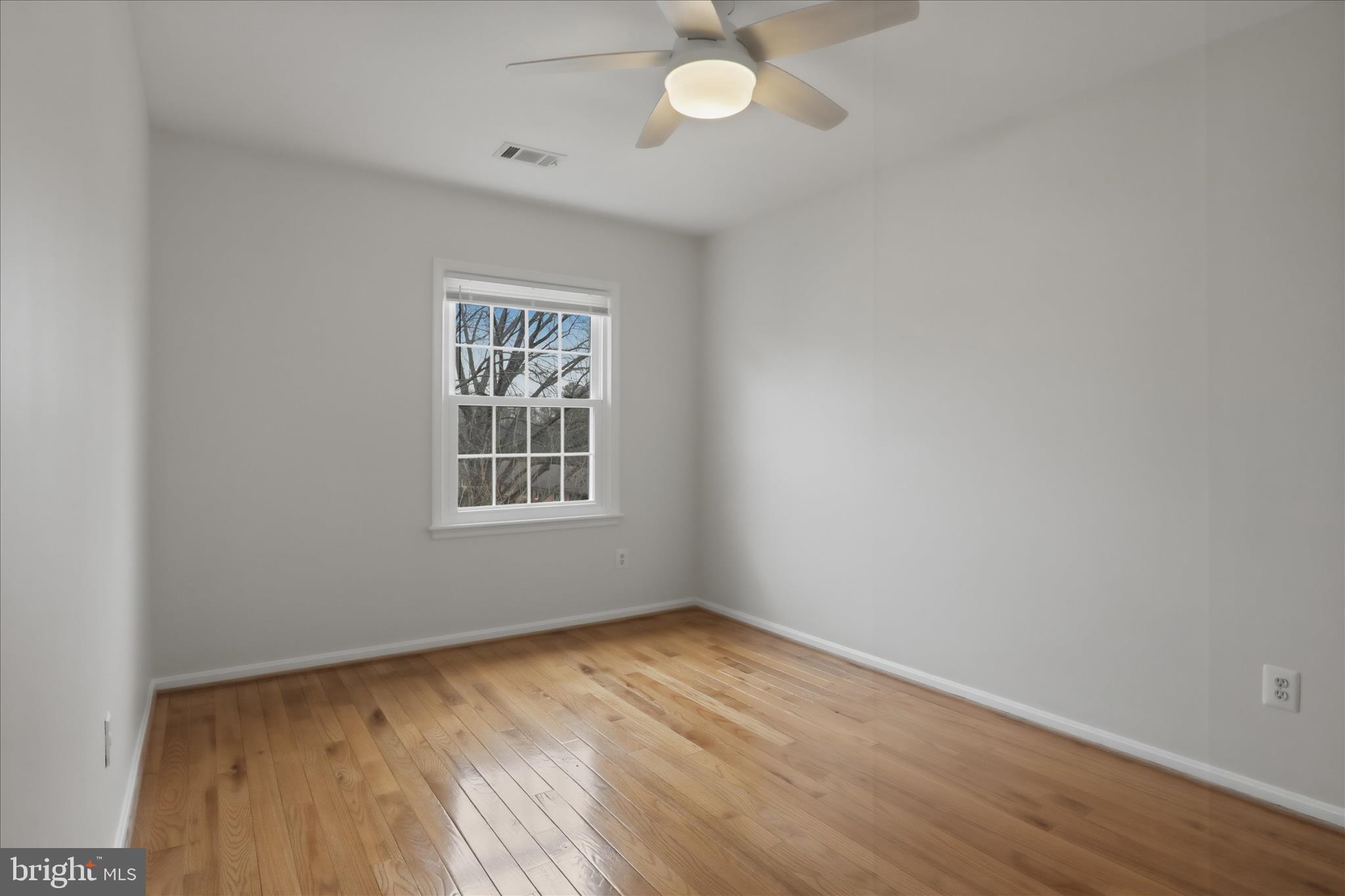 4851 Sangamore Road, Unit 25 Bethesda, MD 20816 - Photo 27 of 41 wooden floor in an empty room with a window