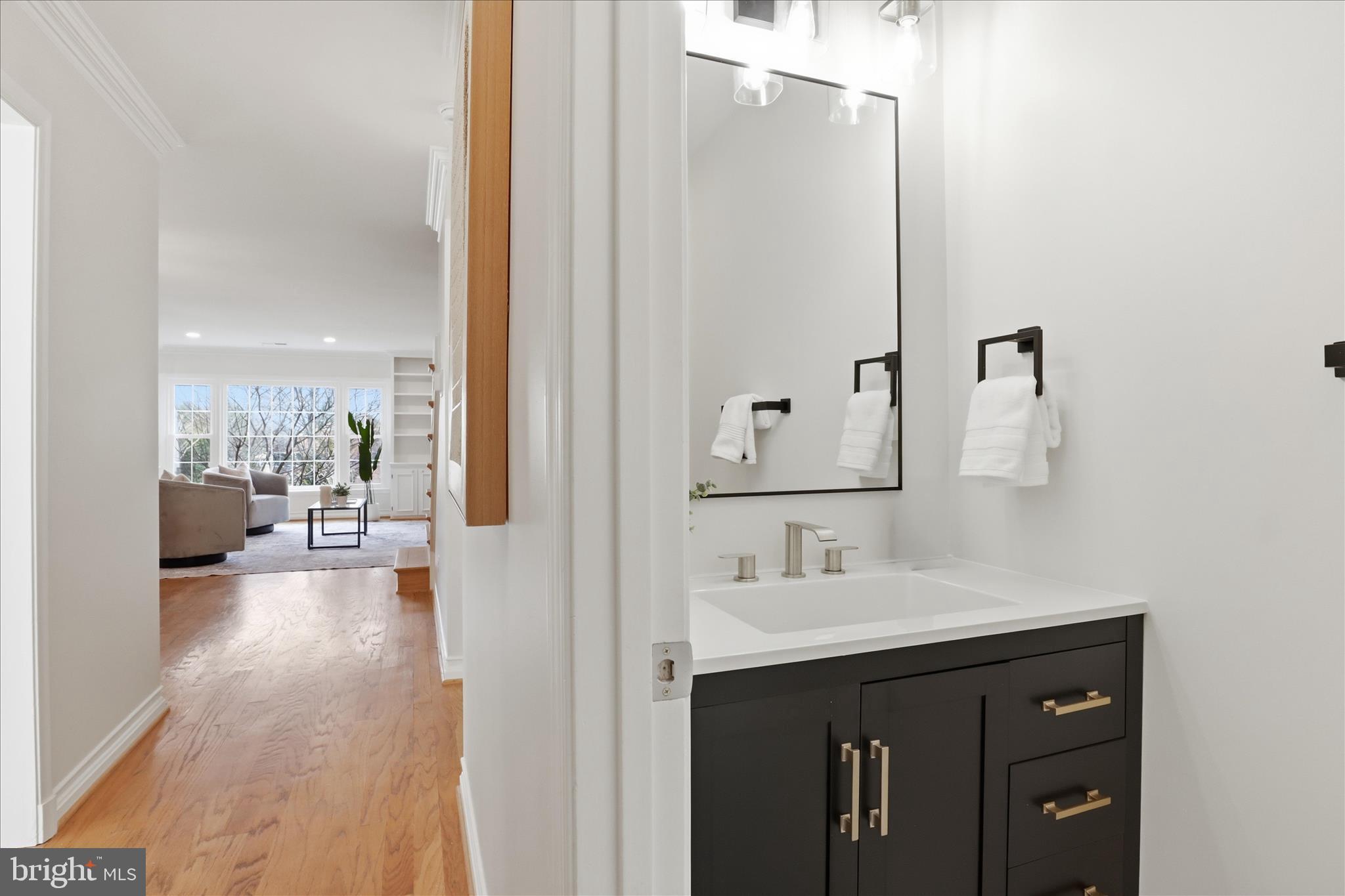4851 Sangamore Road, Unit 25 Bethesda, MD 20816 - Photo 5 of 41 a en suite bathroom with a sink and a mirror