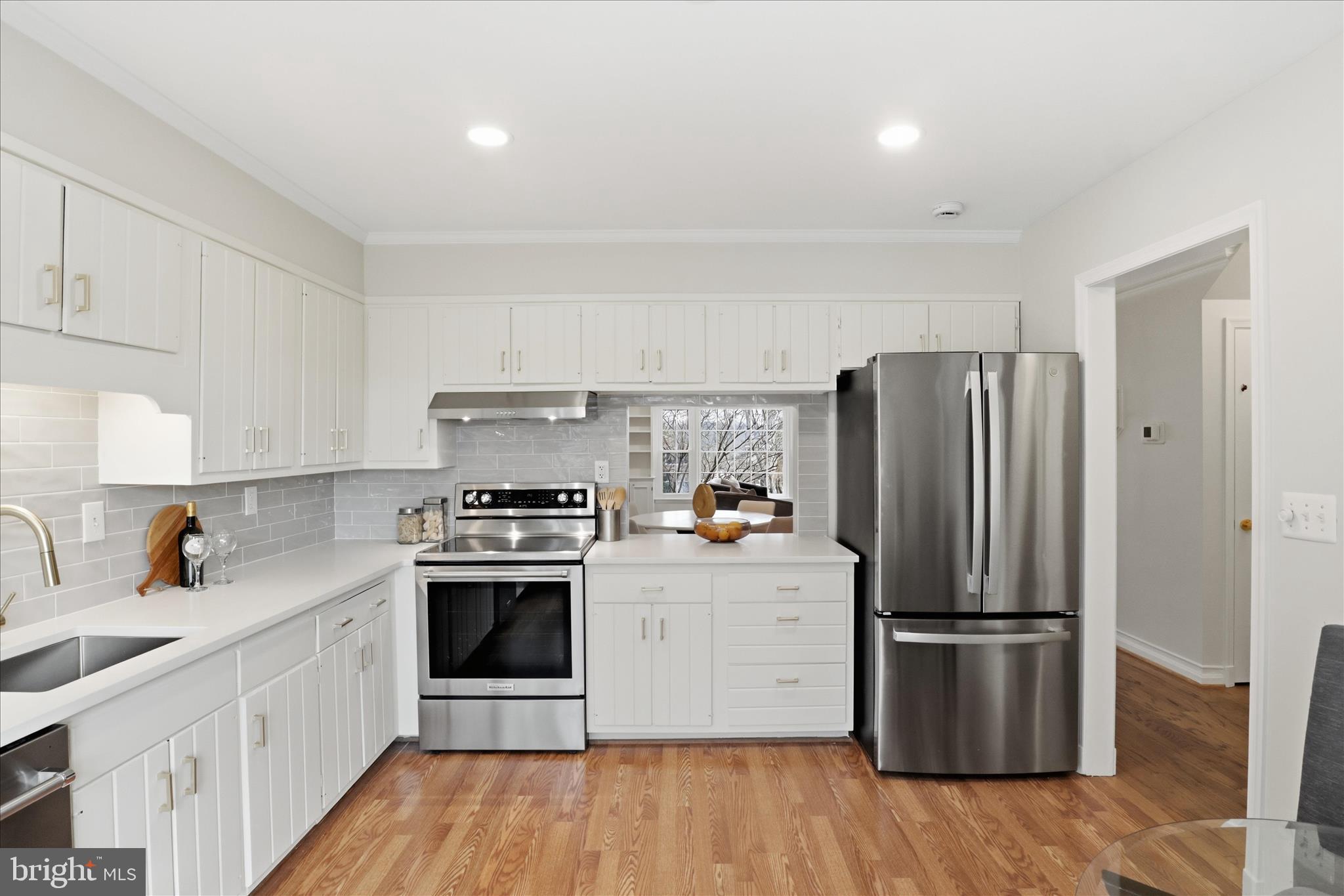 4851 Sangamore Road, Unit 25 Bethesda, MD 20816 - Photo 8 of 41 a kitchen with a refrigerator sink and wooden floor