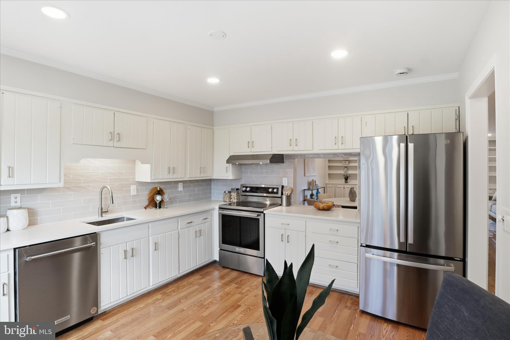 4851 Sangamore Road, Unit 25 Bethesda, MD 20816 - Photo 9 of 41 a kitchen with a refrigerator sink and white cabinets