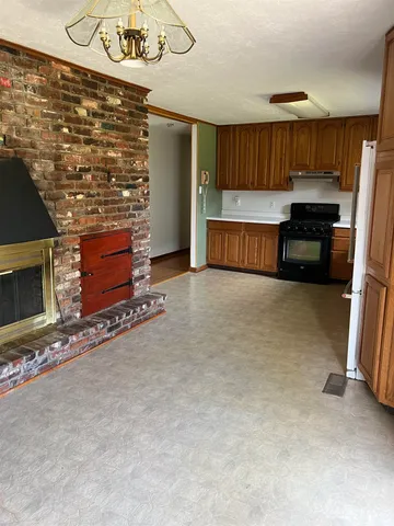 a kitchen with granite countertop a refrigerator and a sink
