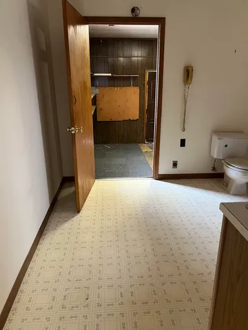 a view of front door with wooden floor