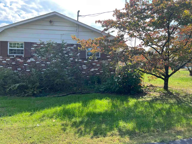 a view of house with backyard