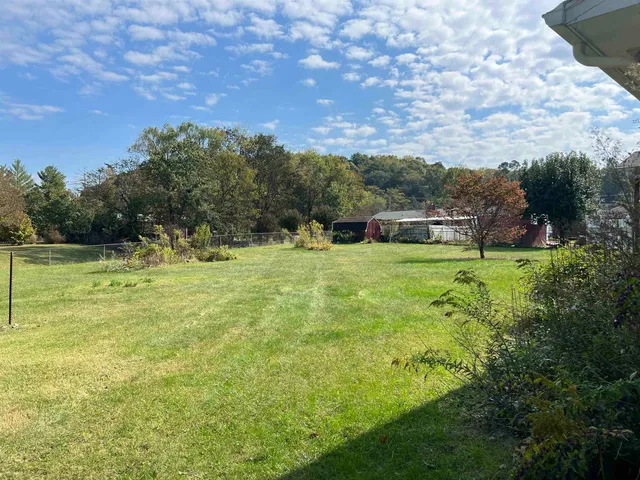 a view of a field with an trees