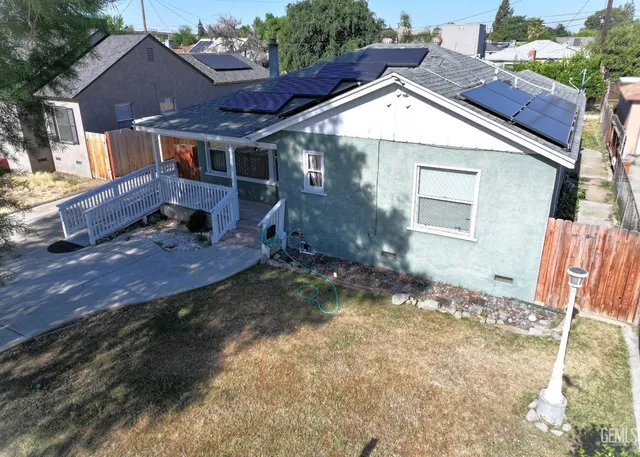 a backyard of a house with yard and outdoor seating