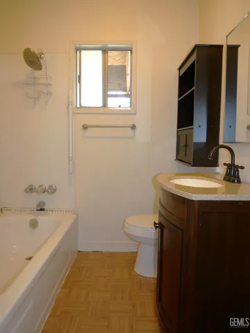 an empty room with windows and ceiling fan