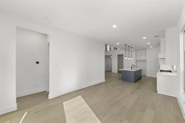 a view of a kitchen with a sink and a refrigerator