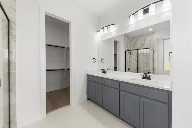 a spacious bathroom with a double vanity sink mirror and double