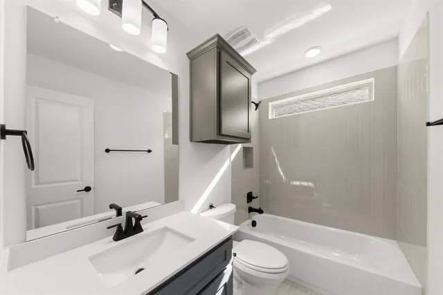 a bathroom with a sink a toilet and a bathtub