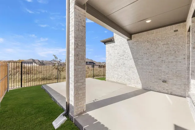 a view of a house with wooden fence