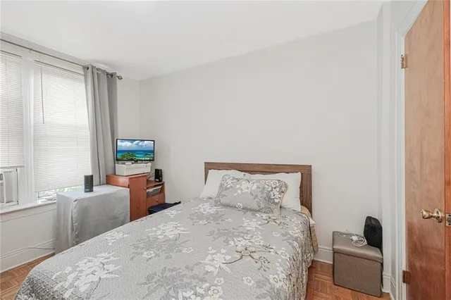 a bedroom with a bed a couch and a window