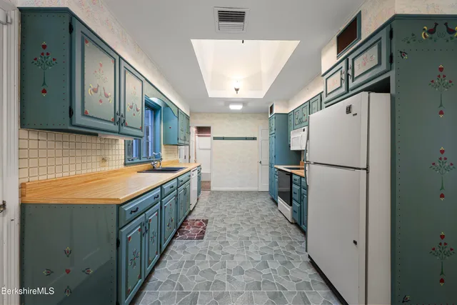 a kitchen with a refrigerator and a sink