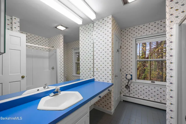 a bathroom with a sink vanity granite and a mirror