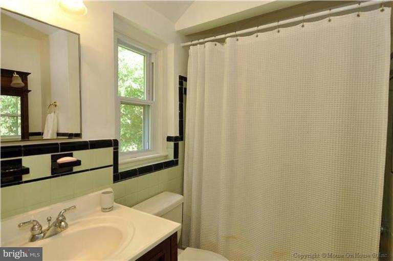 11710 Lytle Street Silver Spring, MD 20902 - Photo 14 of 30 a bathroom with a sink and a mirror