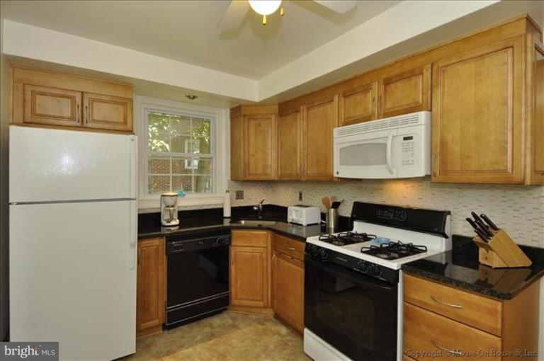 11710 Lytle Street Silver Spring, MD 20902 - Photo 3 of 30 a kitchen with granite countertop a refrigerator stove and sink