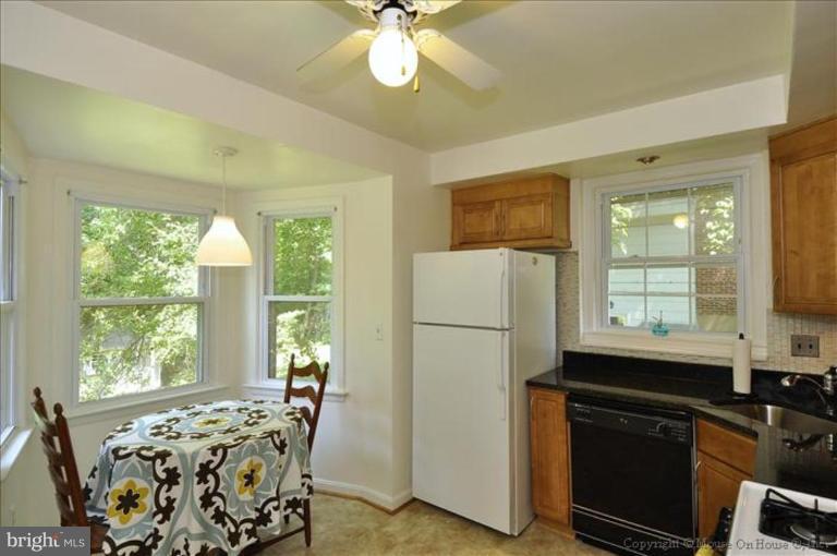 11710 Lytle Street Silver Spring, MD 20902 - Photo 5 of 30 a kitchen with a window a sink and a refrigerator