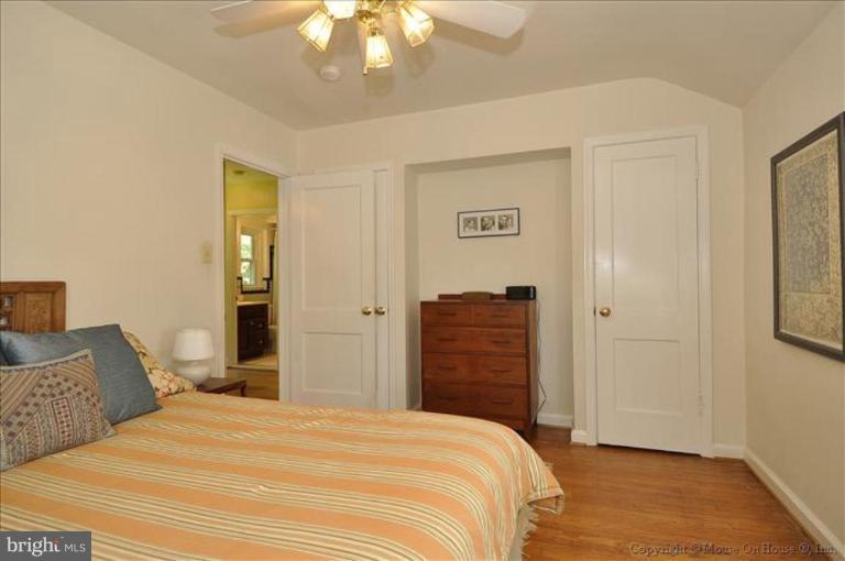 11710 Lytle Street Silver Spring, MD 20902 - Photo 8 of 30 a bedroom with a bed and a chandelier