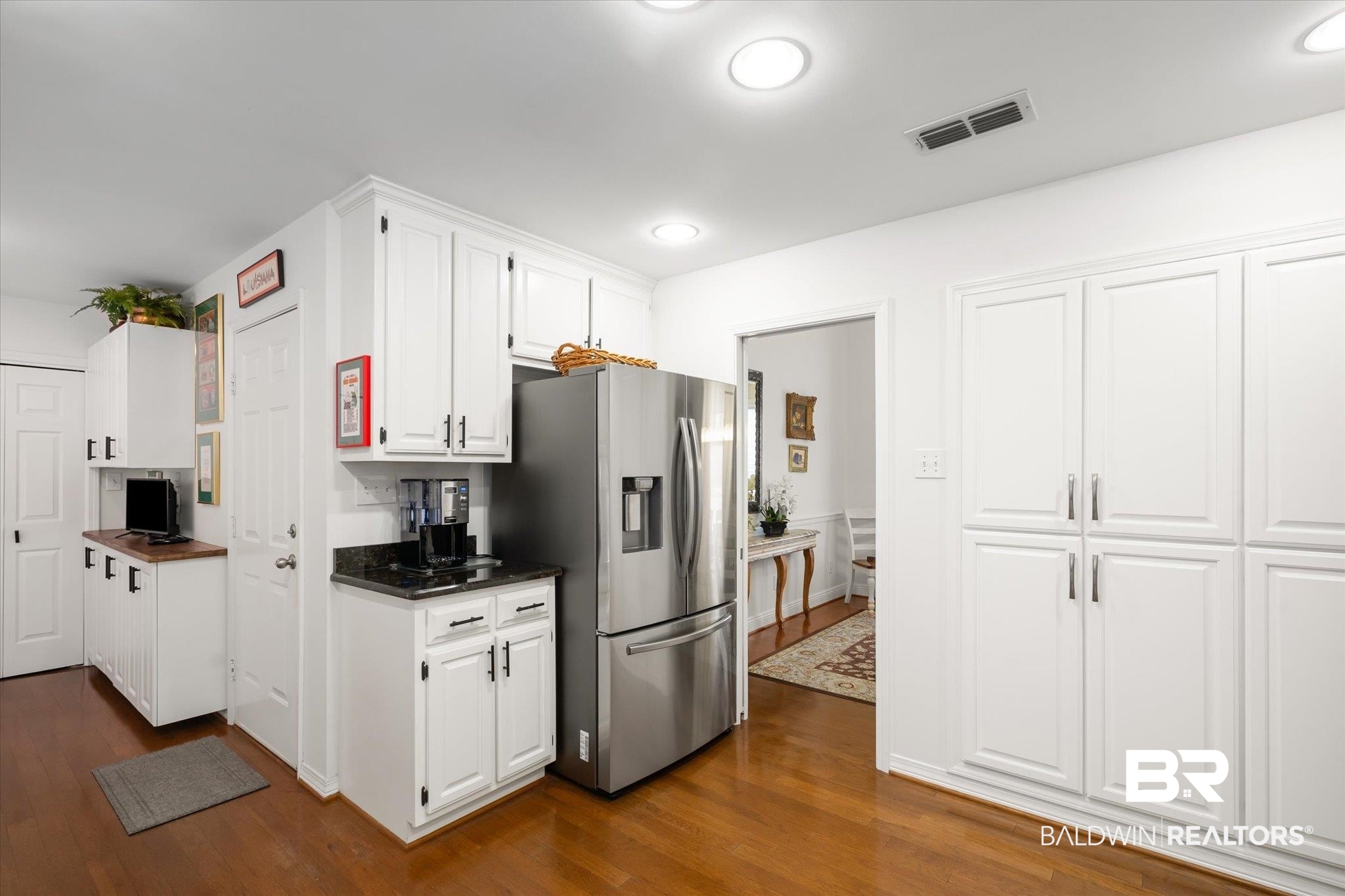 19924 Hunters Loop Fairhope, AL 36532 - Photo 8 of 40 Kitchen featuring white cabinets, stainless steel fridge with ice dispenser, and dark hardwood / wood-style floors