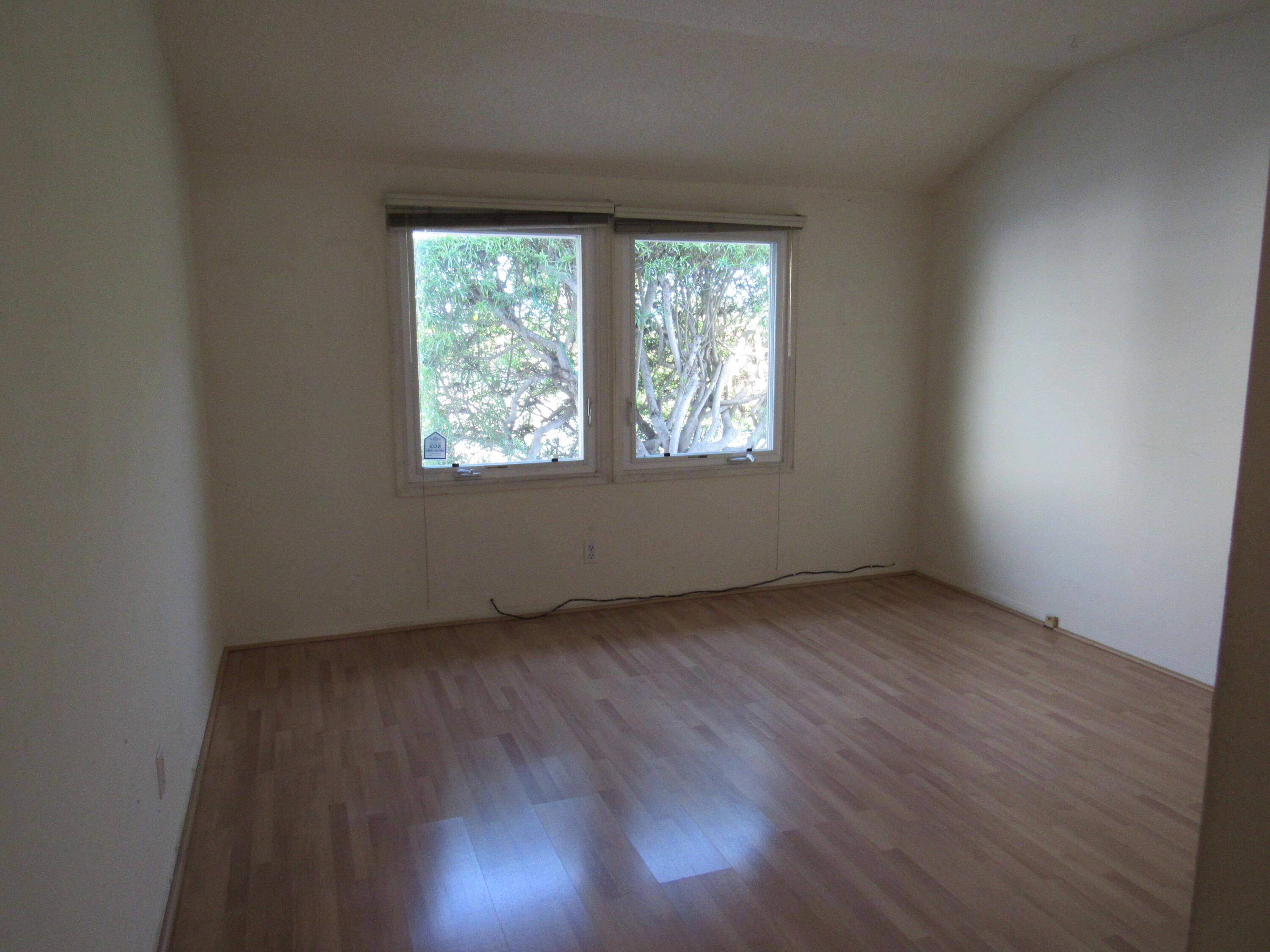 343 Salida Del Sol Santa Barbara, CA 93109 - Photo 12 of 20 an empty room with wooden floor and windows