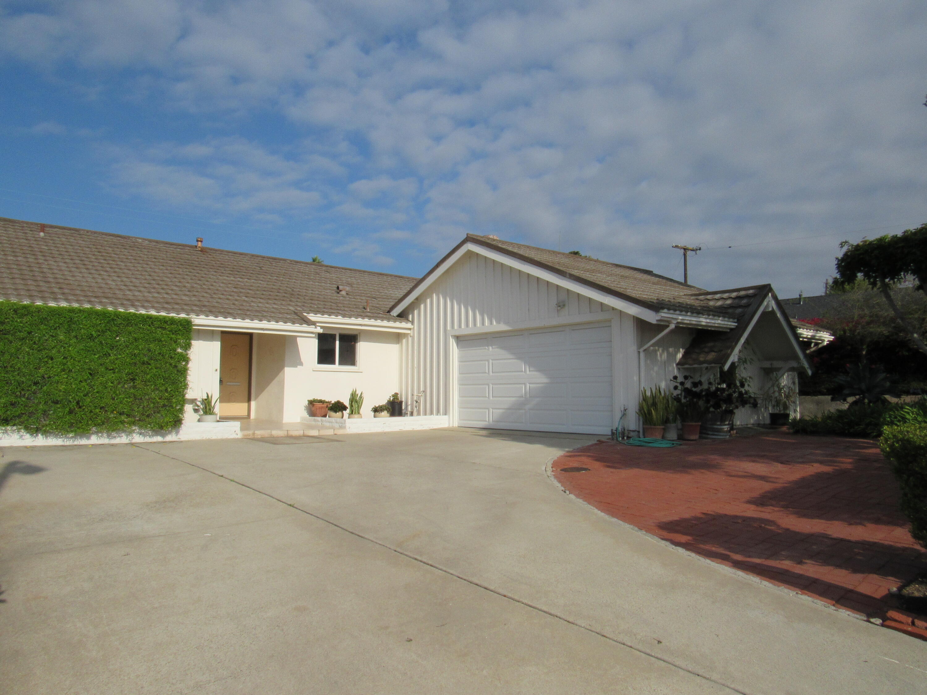 343 Salida Del Sol Santa Barbara, CA 93109 - Photo 2 of 20 a view of a house with a yard and garage
