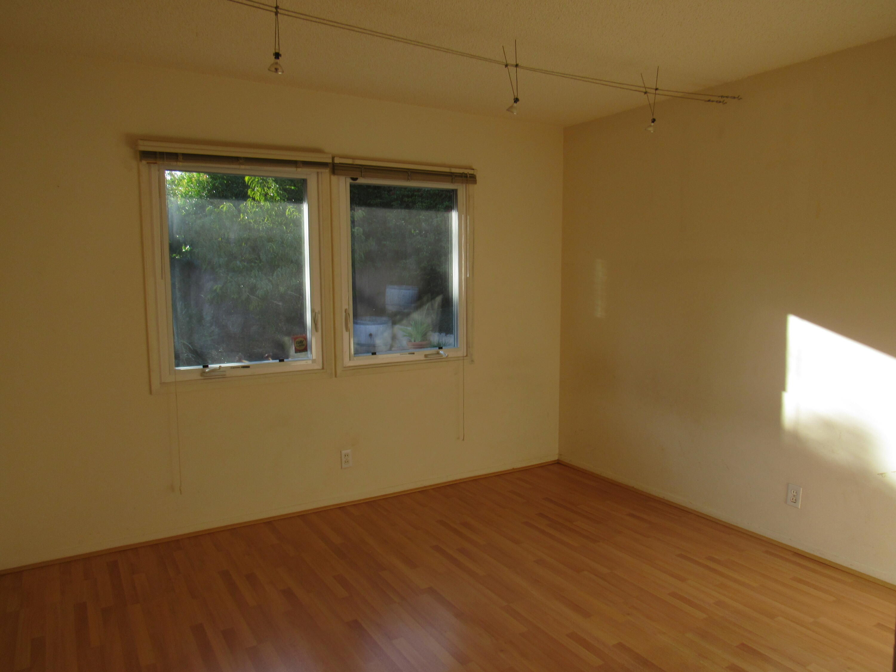 343 Salida Del Sol Santa Barbara, CA 93109 - Photo 10 of 20 an empty room with wooden floor and windows
