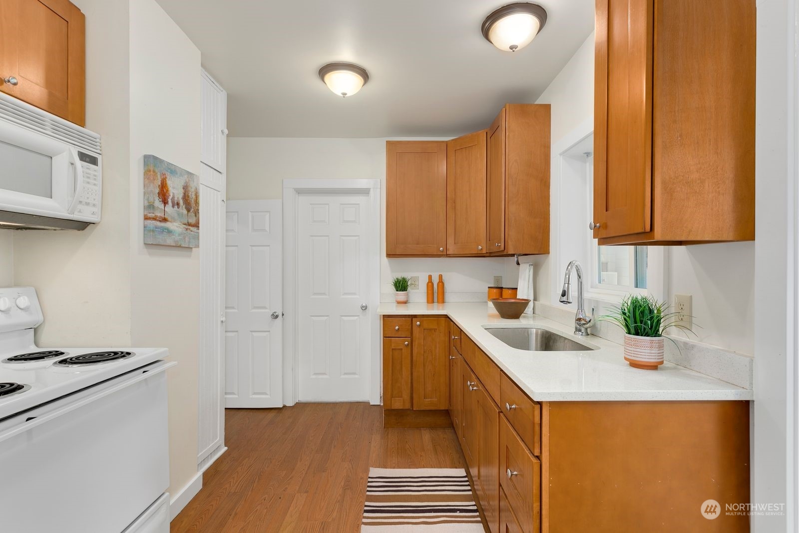 2808 Southwest Genesee Street Seattle, WA 98126 - Photo 15 of 29 a kitchen with a sink a stove and cabinets