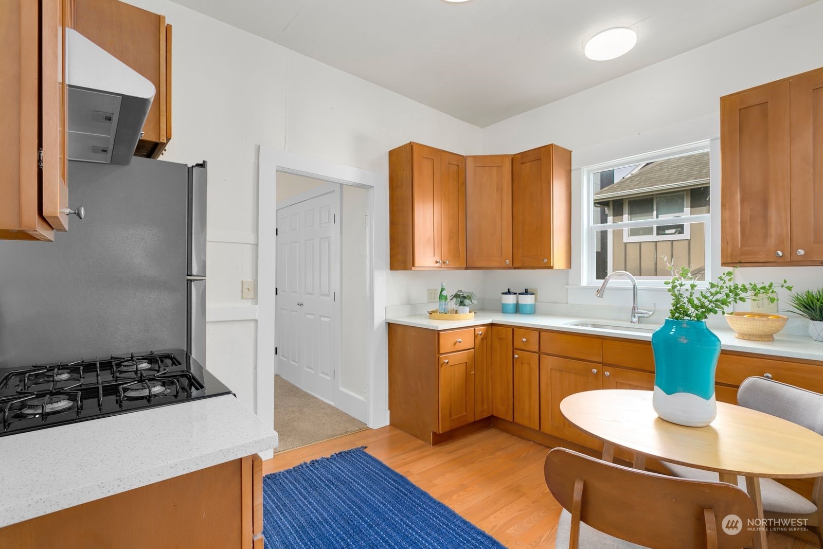 2808 Southwest Genesee Street Seattle, WA 98126 - Photo 7 of 29 a large kitchen with stainless steel appliances granite countertop a sink and a stove