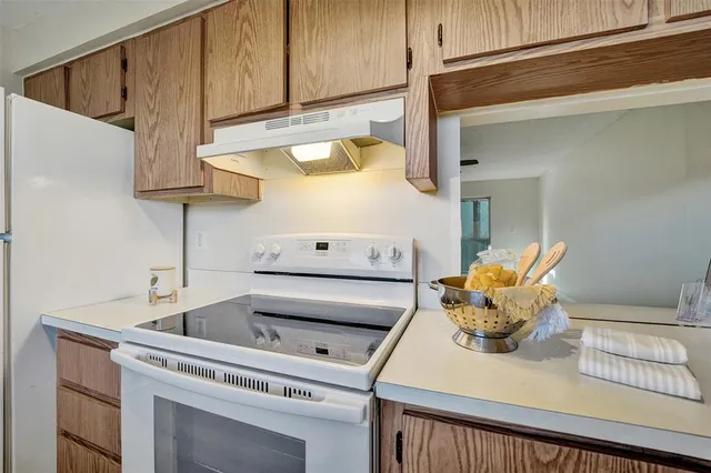 a view of an empty room with a ceiling fan and a window