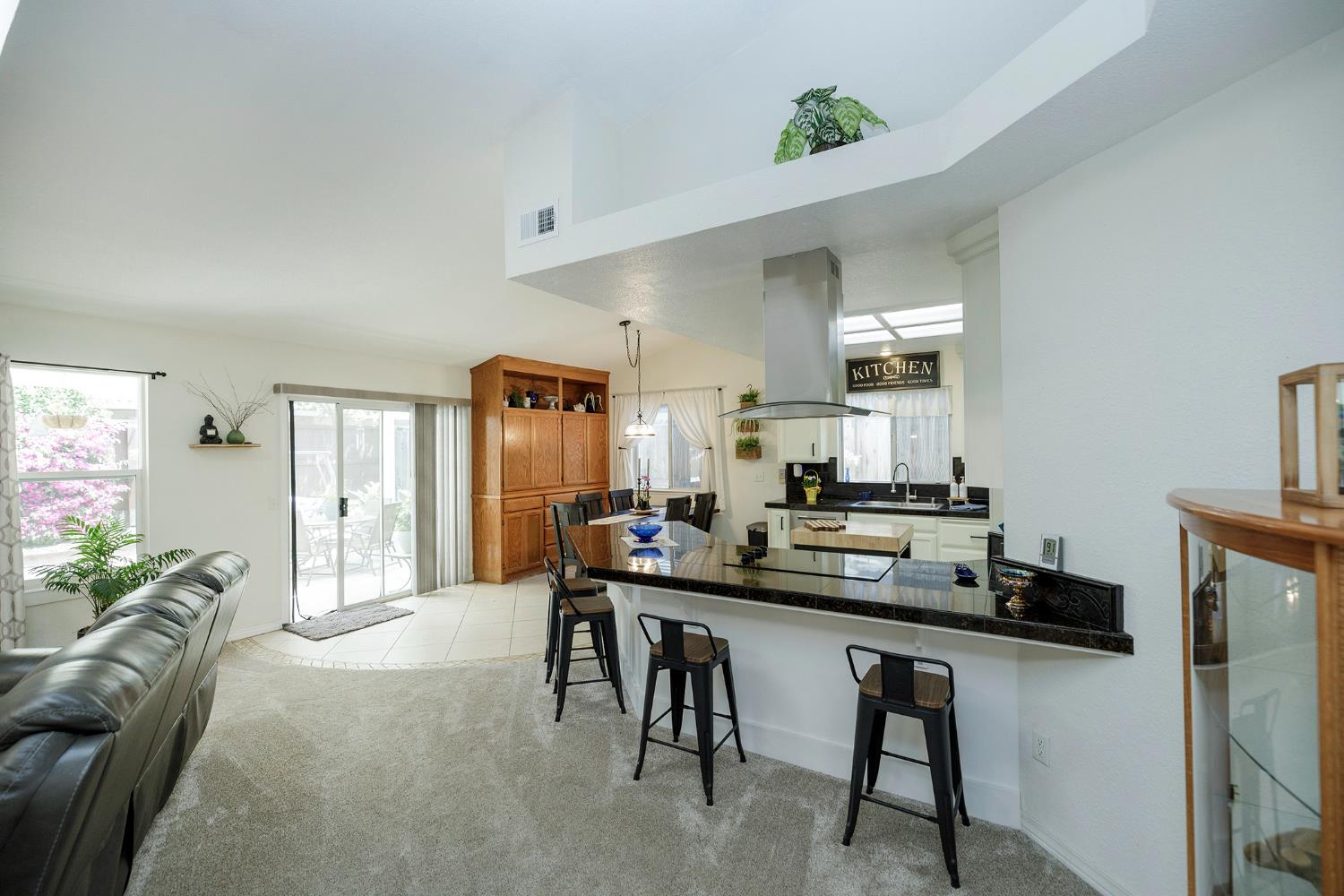 230 Meyenberg Avenue Ripon, CA 95366 - Photo 19 of 52 a dining hall with stainless steel appliances a dining table and chairs with wooden floor