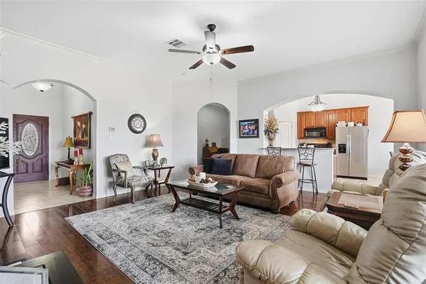 a living room with furniture and a chandelier