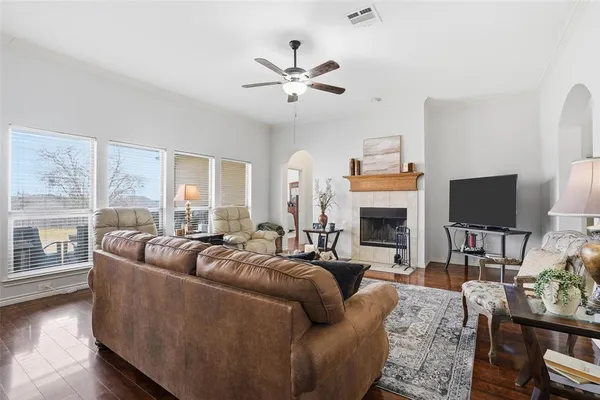 a living room with furniture a fireplace and a flat screen tv