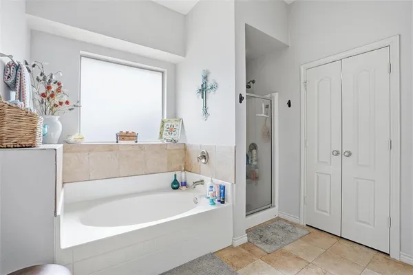 a bathroom with a bathtub and a shower