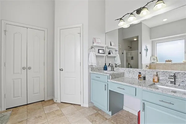 a spacious bathroom with a sink a mirror and a shower