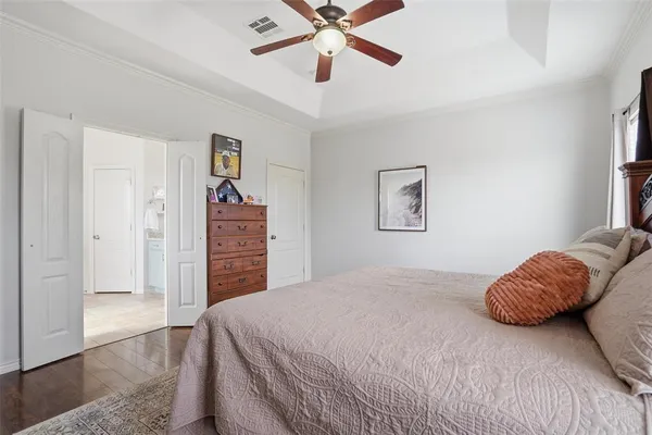 a bedroom with a bed and a chandelier