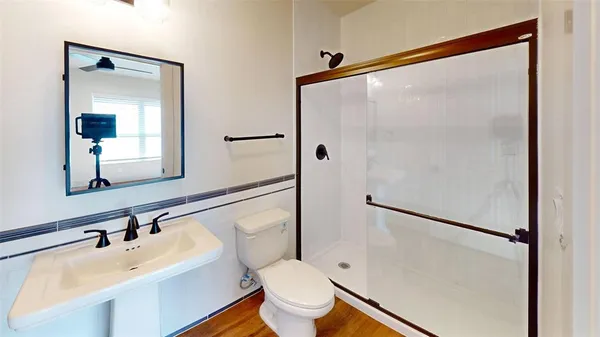 a bathroom with a sink toilet and shower