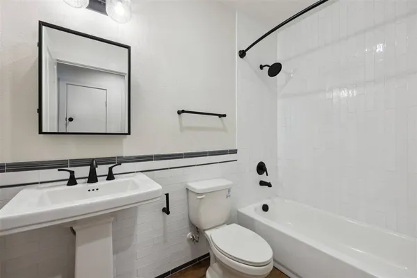 a bathroom with a toilet sink shower and mirror